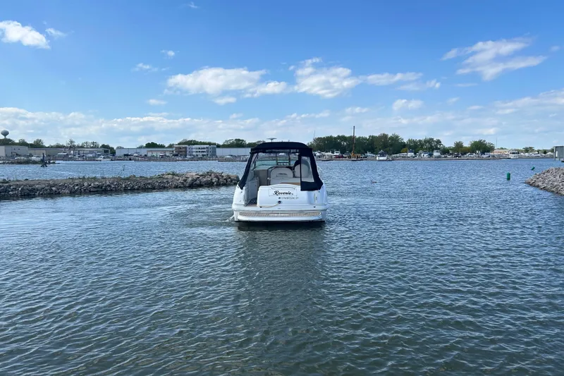 Slide: The Image of 2003 Sea Ray 360 Sundancer boat on calm water under a clear blue sky. - 3