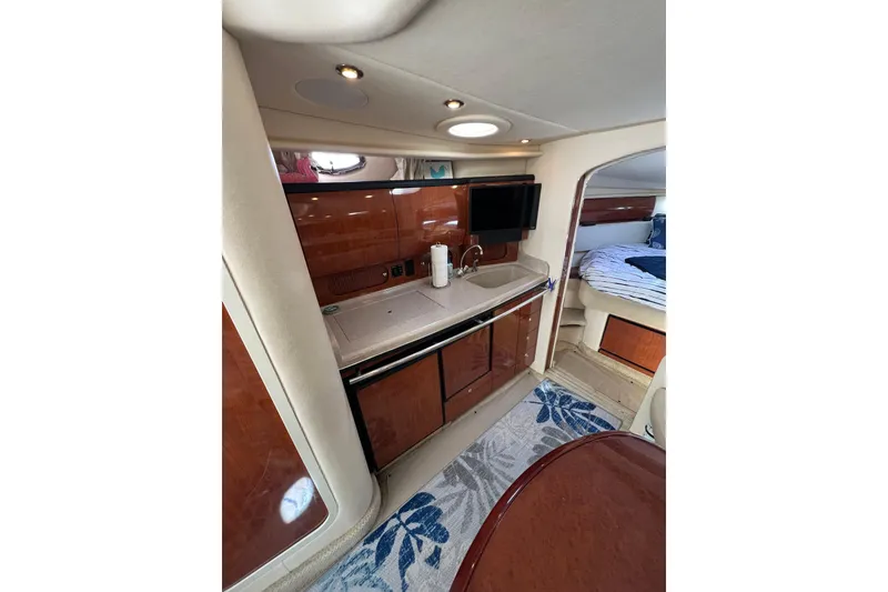 Slide: The Image of Interior of 2003 Sea Ray 360 Sundancer yacht with kitchenette and cozy sleeping area. - 30