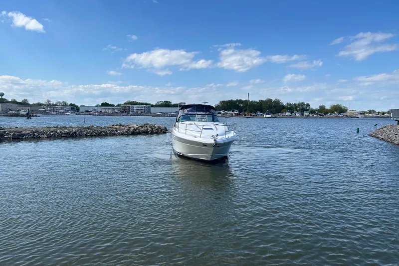 Slide: The Image of 2003 Sea Ray 360 Sundancer yacht cruising in a calm marina under a clear blue sky. - 7