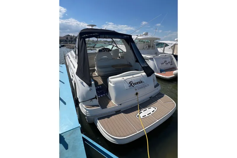 Slide: The Image of 2003 Sea Ray 360 Sundancer docked, rear view with canopy and deck, sunny day. - 8