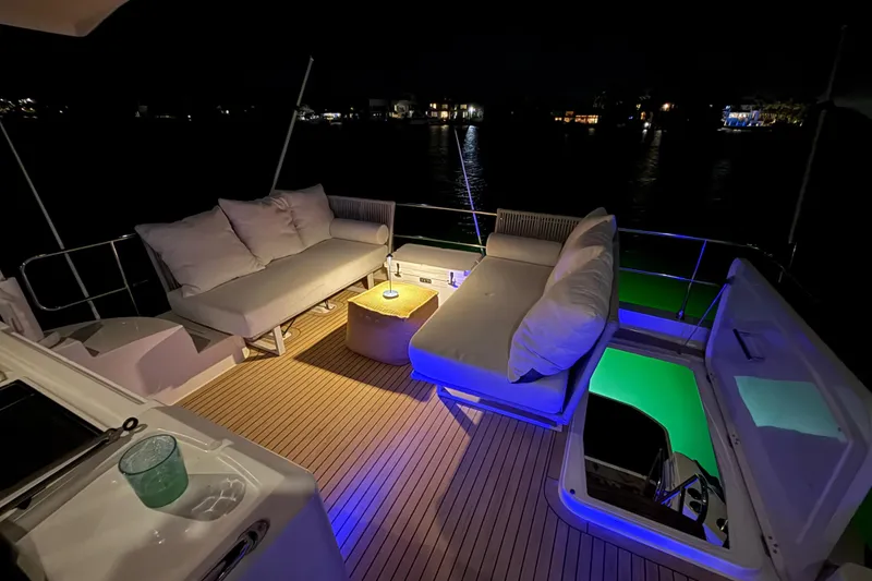 Slide: The Image of Luxurious 2019 Beneteau Swift Trawler 47 deck at night with ambient lighting. - 10