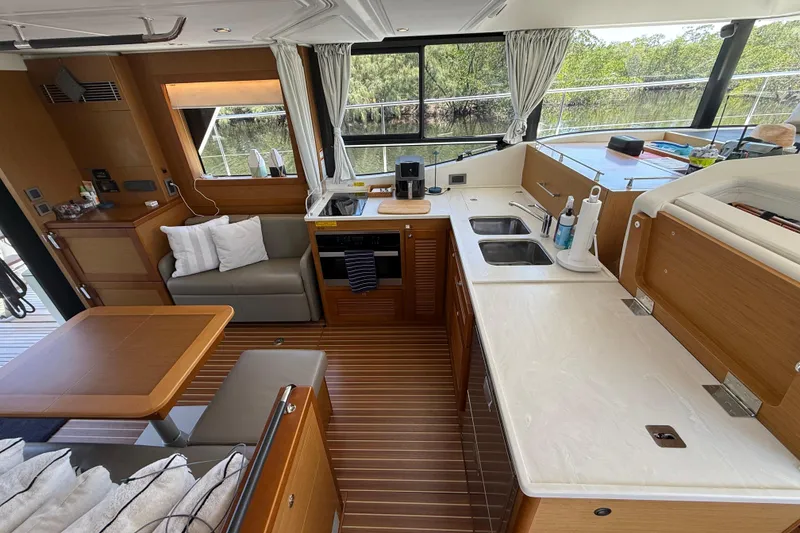 Slide: The Image of Interior of 2019 Beneteau Swift Trawler 47 with modern kitchen and seating area. - 14