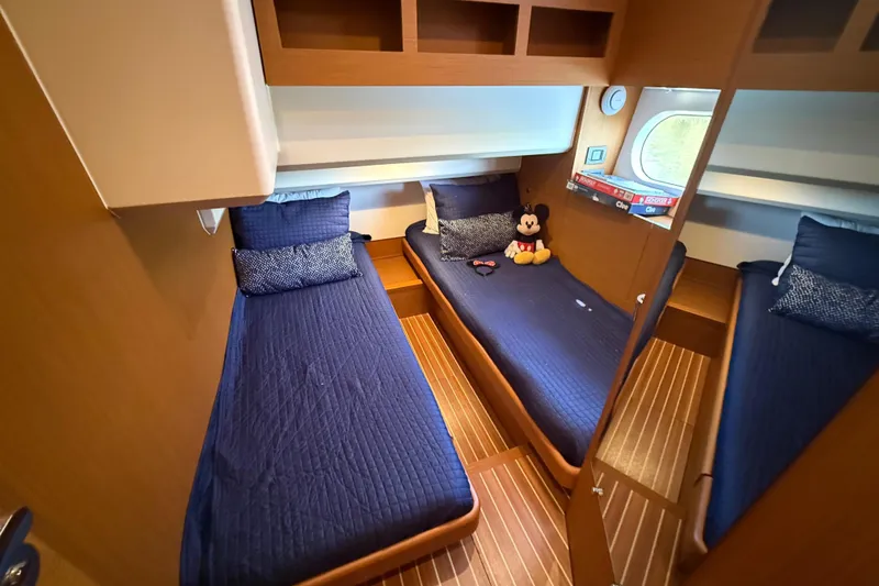 Slide: The Image of 2019 Beneteau Swift Trawler 47 cabin with twin beds and nautical decor. - 17