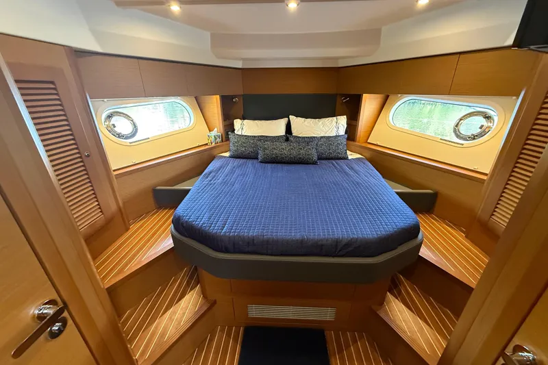 Slide: The Image of Luxurious cabin interior of 2019 Beneteau Swift Trawler 47 with cozy bedding. - 24