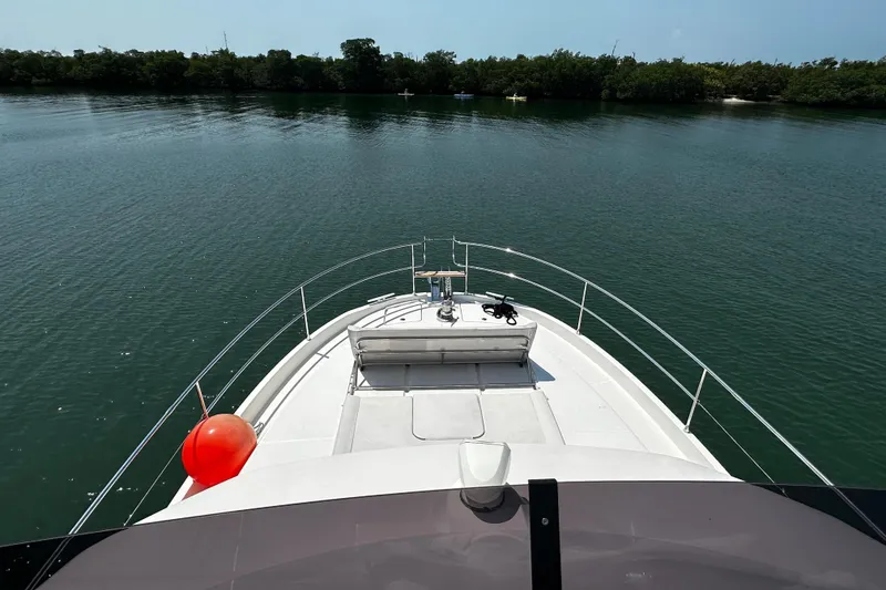 Slide: The Image of 2019 Beneteau Swift Trawler 47 on calm water, view from bow. - 7
