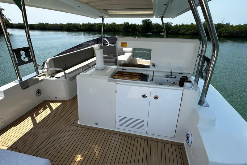 Slide: The Image of 2019 Beneteau Swift Trawler 47 deck with outdoor kitchen and seating area. - 8