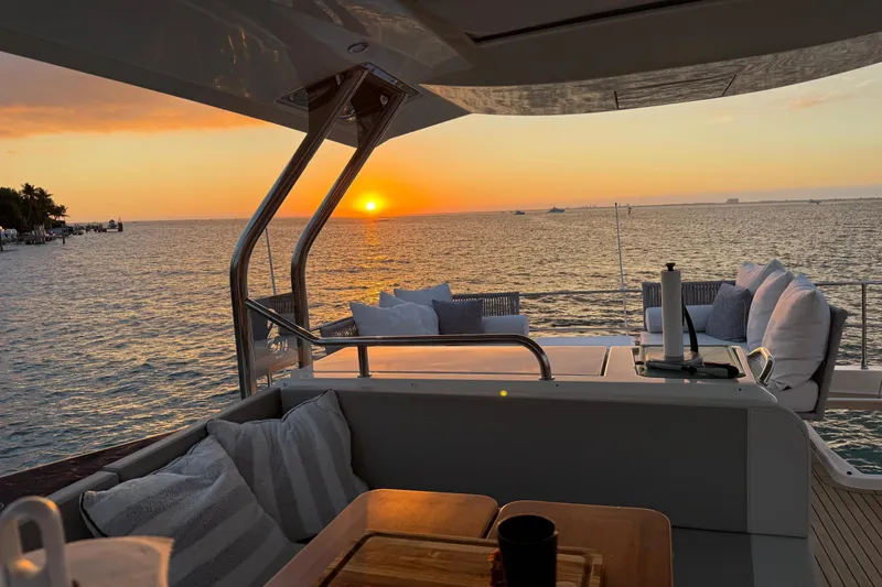 Slide: The Image of 2019 Beneteau Swift Trawler 47 at sunset, featuring a luxurious deck with ocean view. - 9