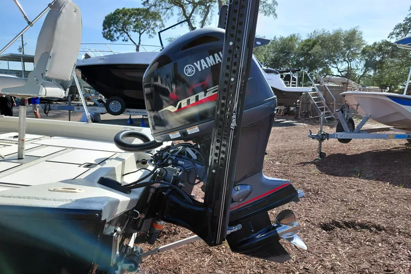 Slide: The Image of 2016 Express 20 BAY boat with Yamaha outboard motor, displayed outdoors. - 10
