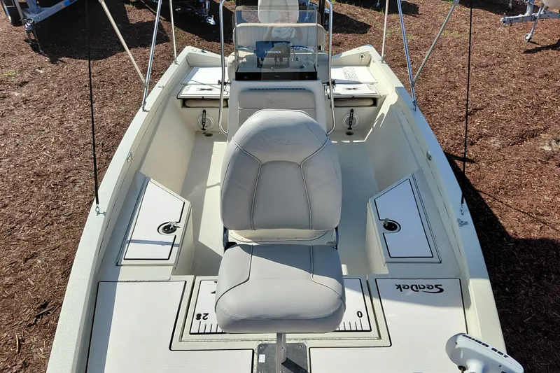 Slide: The Image of 2016 Express 20 BAY boat interior with seating and storage compartments. - 14
