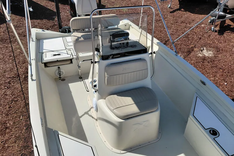 Slide: The Image of 2016 Express 20 BAY boat interior with seating and steering console. - 16