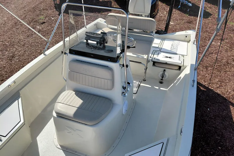 Slide: The Image of 2016 Express 20 BAY boat interior with seating and control panel. - 17
