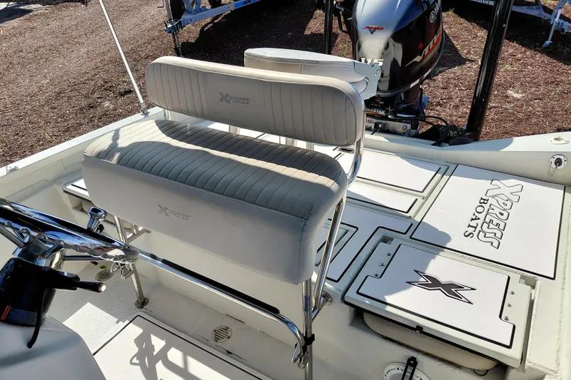 Slide: The Image of 2016 Express 20 BAY boat interior with seating and motor, showcasing Xpress Boats branding. - 25