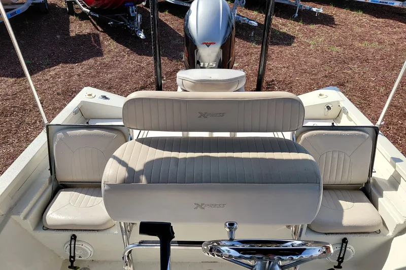 Slide: The Image of 2016 Express 20 BAY boat interior with beige seating and Yamaha 115 outboard motor. - 28
