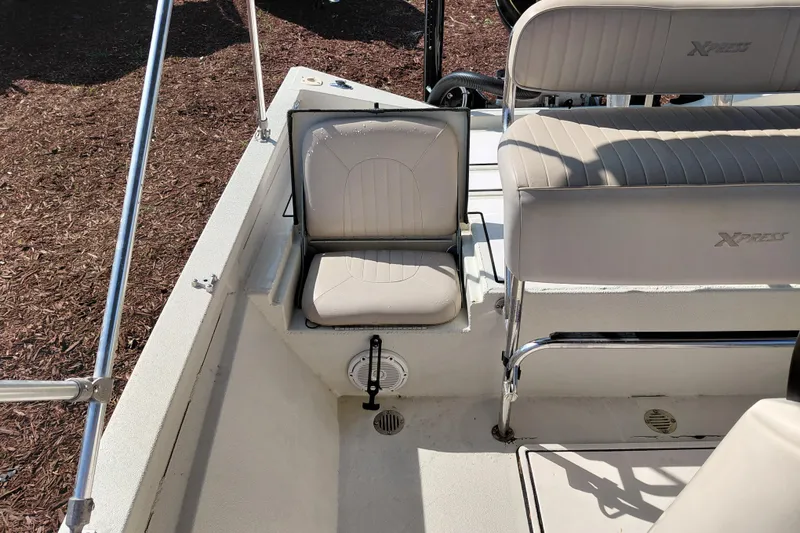 Slide: The Image of 2016 Express 20 BAY boat interior with beige seating and storage compartment. - 29