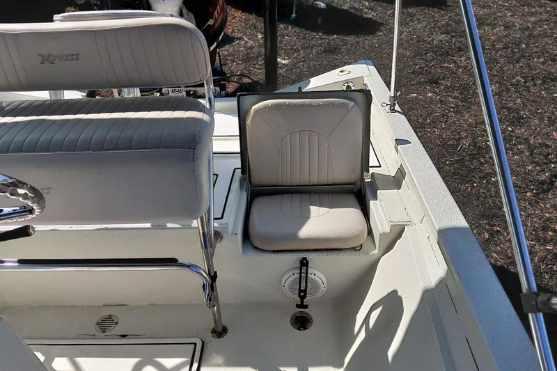 Slide: The Image of 2016 Express 20 BAY boat interior with cushioned seating and steering wheel. - 30