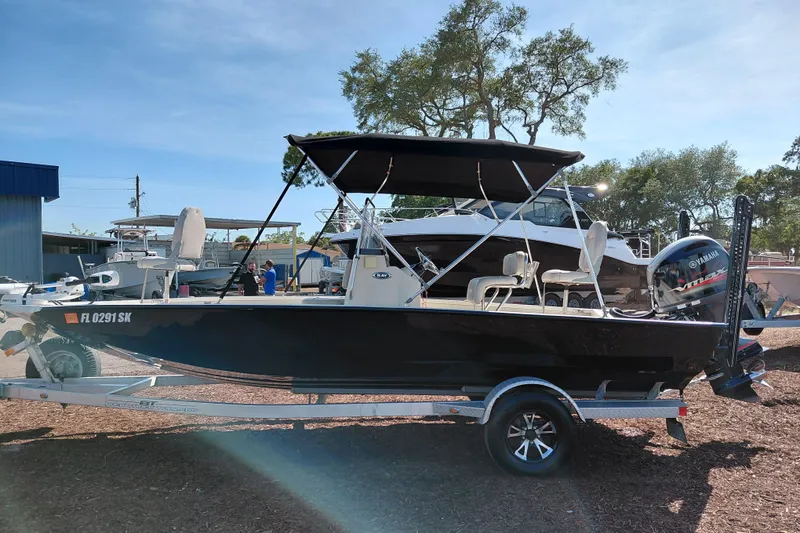 Slide: The Image of 2016 Express 20 BAY boat on trailer with Yamaha outboard motor, parked outdoors. - 5