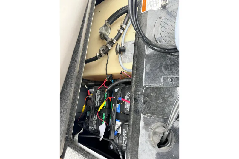 Slide: The Image of 2025 Tracker Bass Tracker Classic XL boat battery compartment with wiring and components. - 11