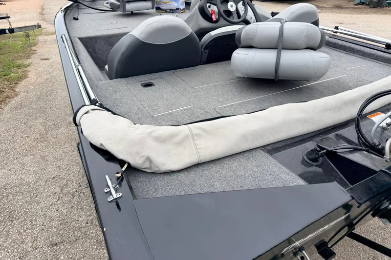 Slide: The Image of 2025 Tracker Bass Tracker Classic XL boat interior with seating and steering wheel. - 12