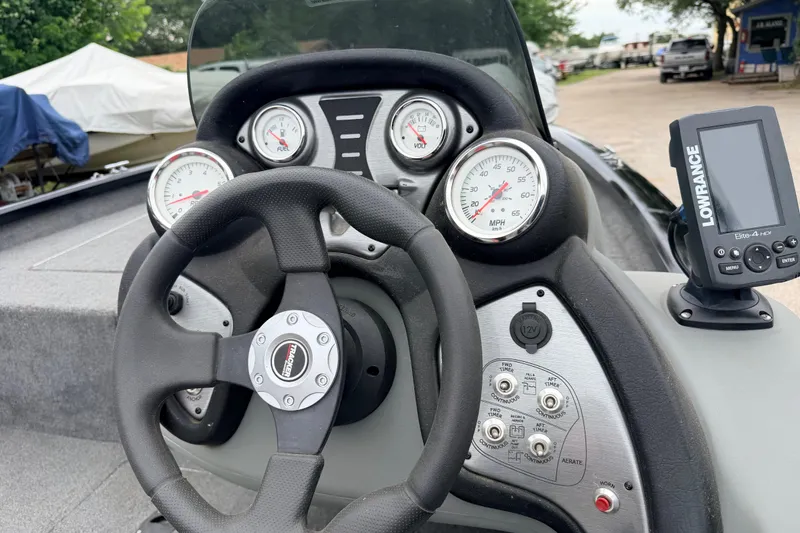 Slide: The Image of 2025 Tracker Bass Tracker Classic XL dashboard with gauges and Lowrance fish finder. - 4