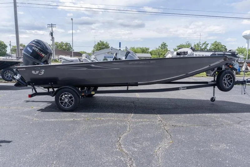 The Image of 2026 G3 Sportsman 1810 boat on trailer, parked outdoors under cloudy sky. - 1