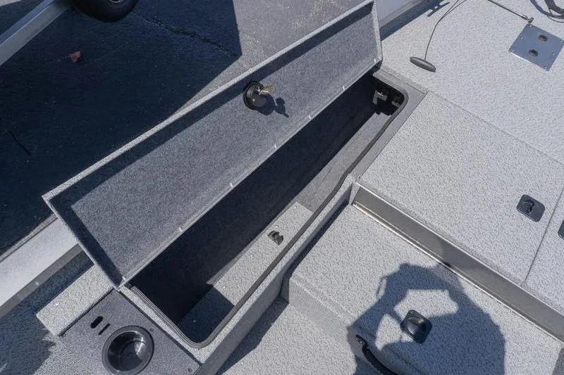 Slide: The Image of 2026 G3 Sportsman 1810 boat storage compartment, open and empty, with gray interior. - 11