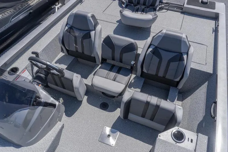 Slide: The Image of 2026 G3 Sportsman 1810 boat interior with gray seating and steering console. - 17