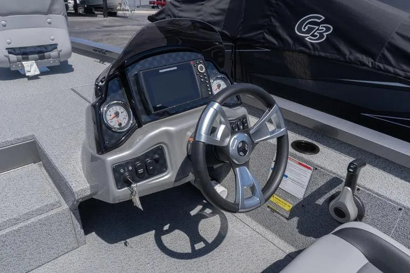 Slide: The Image of 2026 G3 Sportsman 1810 boat dashboard with steering wheel and control panel. - 8