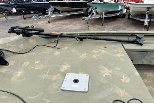 Slide: The Image of 2017 Tracker Grizzly 1654 MVX Sportsman boat deck with camouflage pattern and mounted equipment. - 10