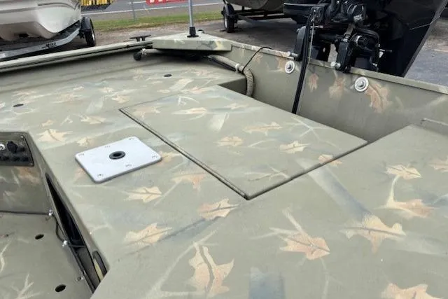 Slide: The Image of 2017 Tracker Grizzly 1654 MVX Sportsman boat with camouflage interior design. - 13