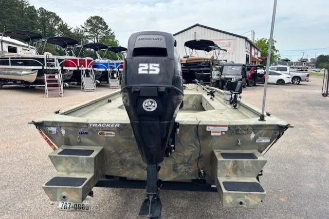 Slide: The Image of 2017 Tracker Grizzly 1654 MVX Sportsman boat with Mercury 25 engine, parked outdoors. - 3
