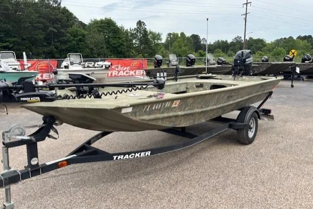 Slide: The Image of 2017 Tracker Grizzly 1654 MVX Sportsman boat on trailer, displayed outdoors. - 6