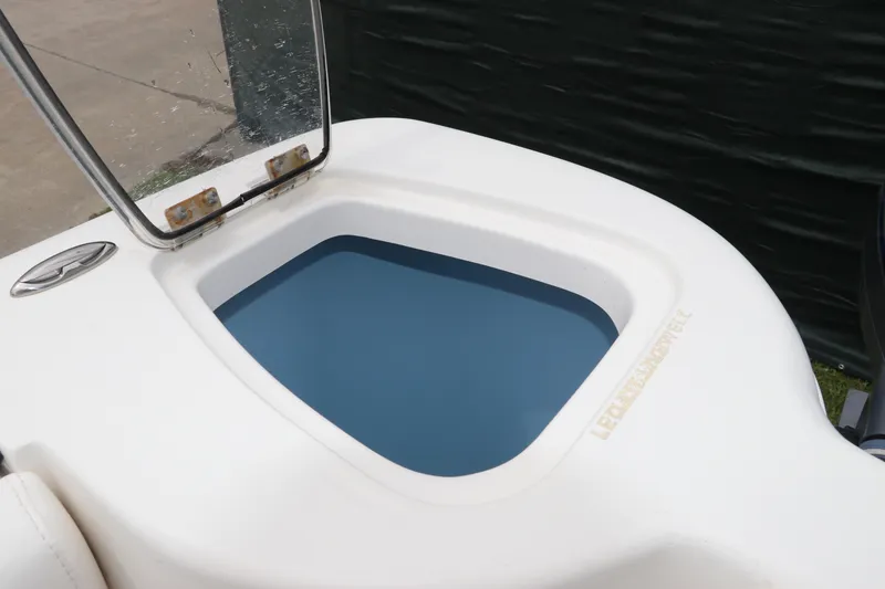Slide: The Image of Open livewell on 2017 Tidewater 252 CC Adventure boat, showcasing interior design. - 14