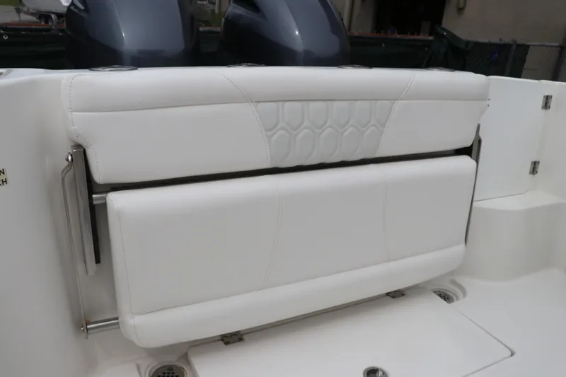 Slide: The Image of 2017 Tidewater 252 CC Adventure boat with white cushioned seating and dual outboard motors. - 15