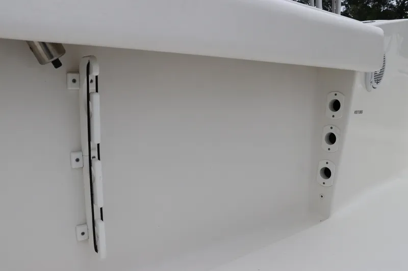 Slide: The Image of 2017 Tidewater 252 CC Adventure boat interior detail with rod holders and speaker. - 17