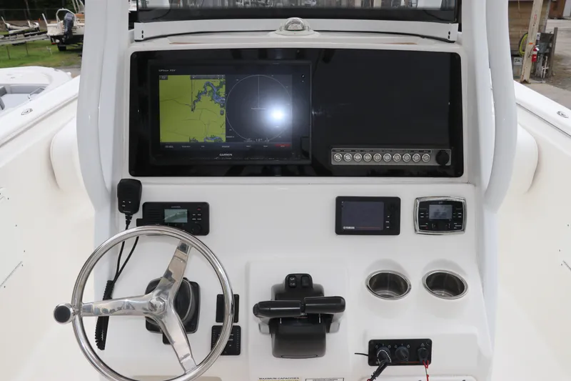 Slide: The Image of 2017 Tidewater 252 CC Adventure boat dashboard with navigation and control systems. - 23