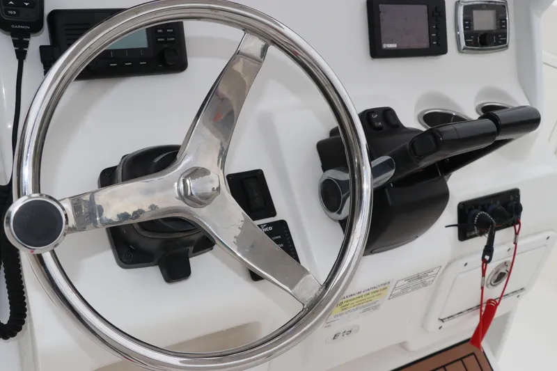 Slide: The Image of Steering console of 2017 Tidewater 252 CC Adventure boat with navigation controls. - 26