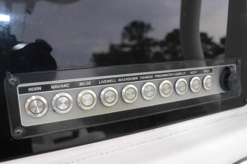 Slide: The Image of Control panel of 2017 Tidewater 252 CC Adventure boat with labeled buttons. - 28