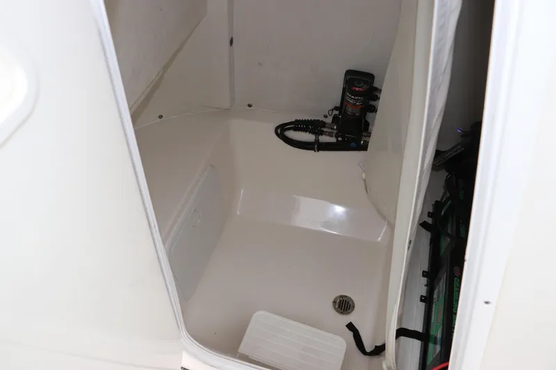 Slide: The Image of Interior view of 2017 Tidewater 252 CC Adventure boat compartment with equipment. - 35