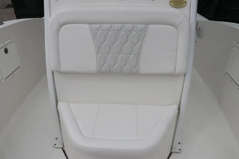 Slide: The Image of White cushioned seat on 2017 Tidewater 252 CC Adventure boat, featuring hexagonal stitching. - 39