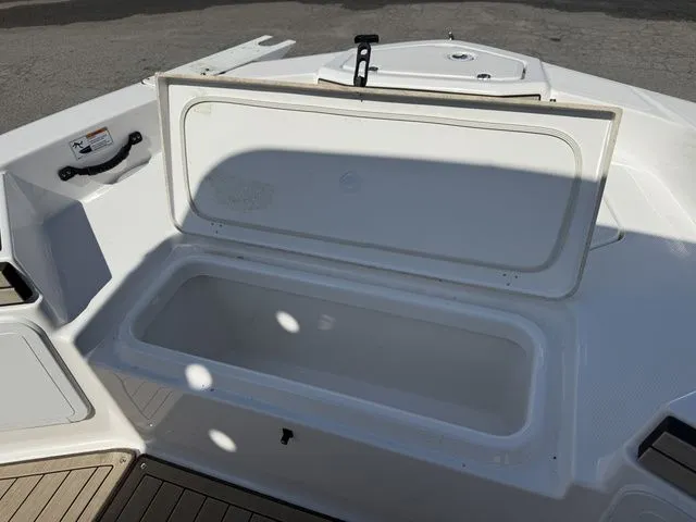 Slide: The Image of Open storage compartment on a 2021 Yamaha Boats 195S model. - 15
