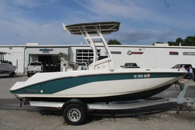 Slide: The Image of 2021 Yamaha Boats 195S on trailer in front of a building. - 4