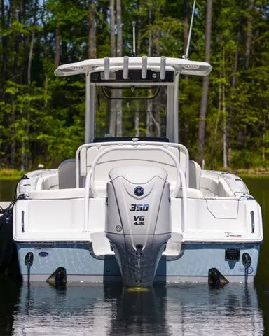 Slide: The Image of Rear view of Sea Hunt Ultra 255 SE boat, 2026 model, on a calm lake. - 13