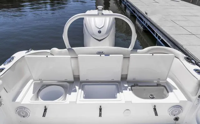 Slide: The Image of Sea Hunt Ultra 255 SE 2026 with open rear storage at dock. - 4