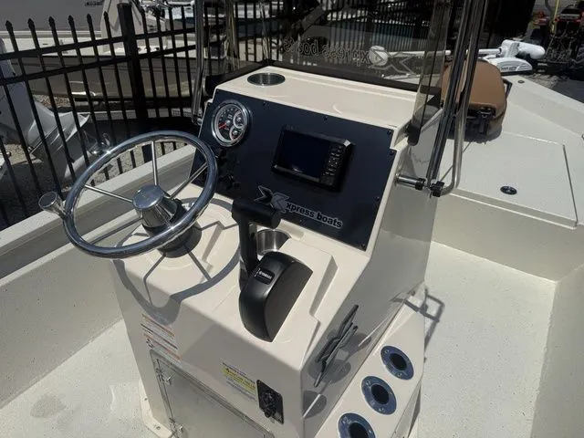 Slide: The Image of Xpress Boats H190B 2026 helm with steering wheel and controls. - 15
