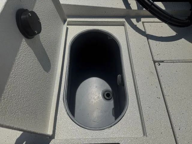 Slide: The Image of 2026 Xpress Boats H190B storage compartment with open lid. - 19