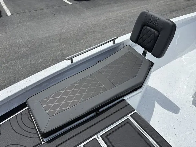 Slide: The Image of 2026 Xpress Boats XR21B seating area with cushioned lounge seat. - 13