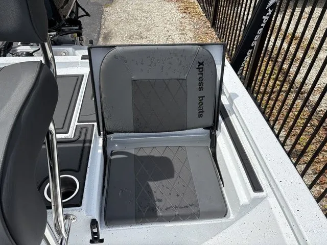 Slide: The Image of Xpress Boats XR21B 2026 seat with gray upholstery and logo. - 26