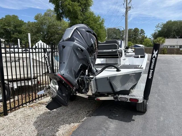 Slide: The Image of 2026 Xpress Boats XR21B with outboard motor on trailer. - 4