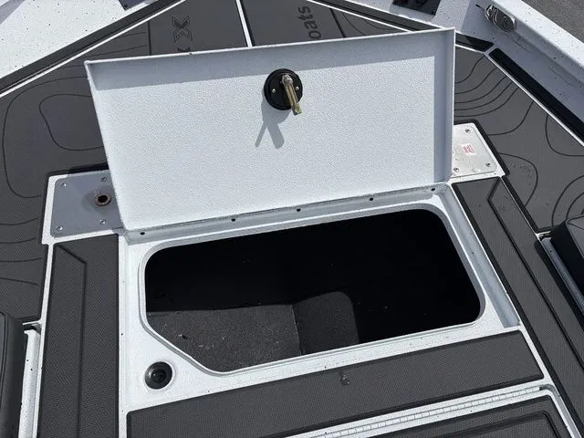 Slide: The Image of Open storage compartment on a 2026 Xpress Boats XR21B. - 8