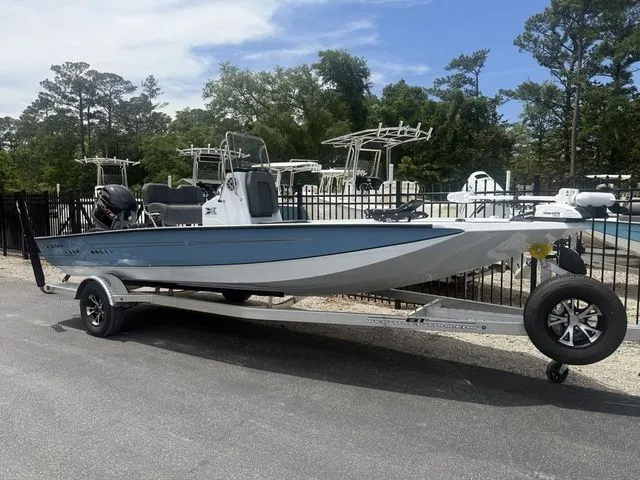 The Image of 2026 Xpress Boats H20B on trailer, blue hull, parked outdoors. - 1